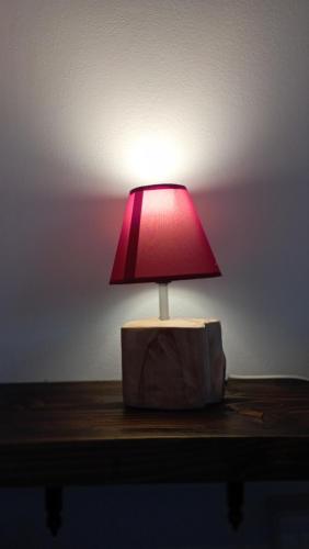 a red lamp sitting on top of a table at Polani - Il Noceto in Cave