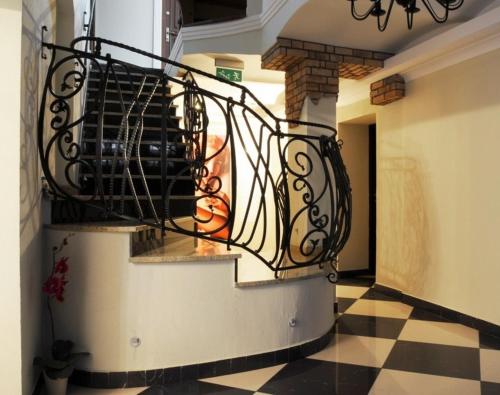 a spiral staircase in a room with a checkered floor at Villa Solankowa in Inowrocław