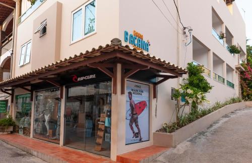 a store with a sign on the side of a building at Pousada Bahia Bacana in Morro de São Paulo