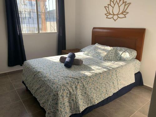 a bedroom with a bed with a teddy bear on it at CASA JARDIN in Cancún