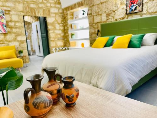 a bedroom with a bed and three vases on a table at Casa Soderini in Tarquinia