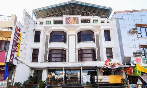 a white building with a sign on it at Treebo Trend The Shagun Peer Gate in Bhopal