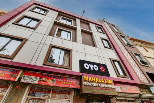 a building with signs on the side of it at Hotel O Mahalaxmi lodge in Cuttack