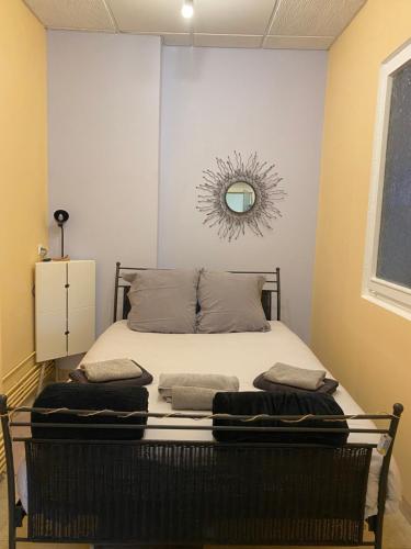 une chambre avec un lit avec un miroir au mur dans l'établissement Appartement lumineux rez-de-chaussée prox GARE, à Cambrai