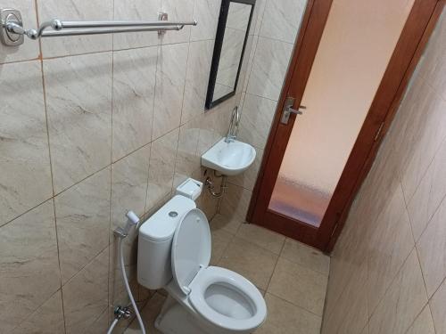 ein Bad mit einem WC und einem Waschbecken in der Unterkunft Nyoman House Ubud in Ubud