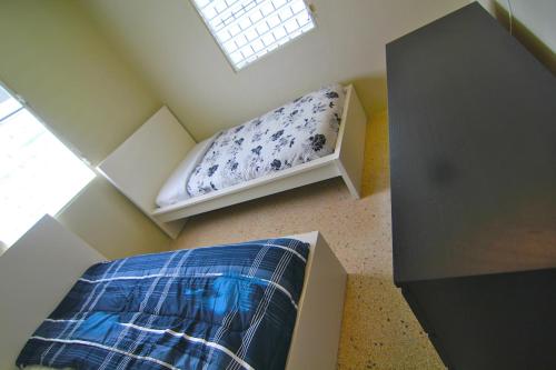a room with a bench in a attic with a window at 3 Bedroom Home Best Price Bayamon by Rentalspr in Bayamon
