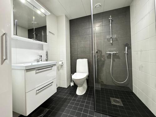 uma casa de banho com um chuveiro, um WC e um lavatório. em Stay with locals at Tripla (room) em Helsínquia