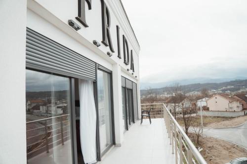 a balcony with windows and a view of a city at Hotel & Restaurant Frida in Gjakove