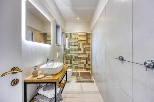 a bathroom with a sink and a toilet and a shower at Villa AnaLucija in Labin