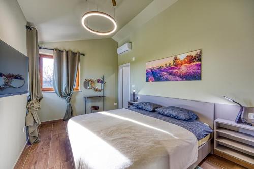 a bedroom with a large white bed with blue pillows at Villa AnaLucija in Labin