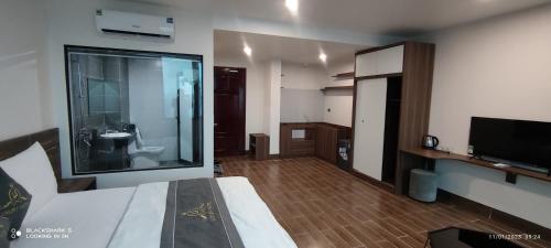 a hotel room with a bedroom with a bathroom at LS HOTEl in Kim Bảng
