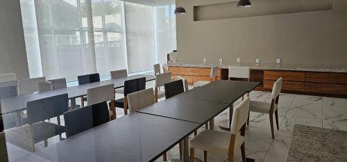 a conference room with a long table and chairs at Option Full Service Residence in Rio de Janeiro