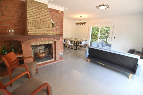 a living room with a couch and a fireplace at RNET - MT - Casa Can Carles in Roses