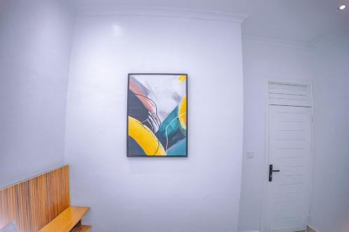a painting hanging on a wall next to a door at Makeri Residence - Musanze , Rwanda in Ruhengeri