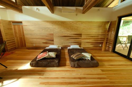 Duas camas num quarto com pisos em madeira em Kumage-gun - Glamping - Vacation STAY 73083v em Yakushima