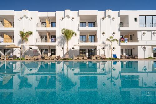 a swimming pool in front of a building at Acquaviva village in Gammarth