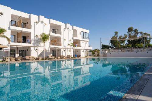 a swimming pool in front of a building at Acquaviva village in Gammarth