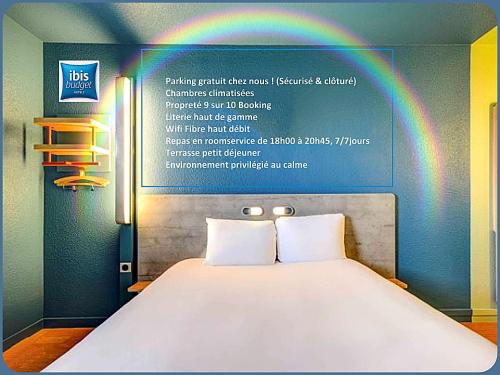 a poster of a bed with a rainbow above it at Ibis Budget Le Havre Les Docks in Le Havre