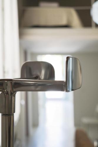 a close up of a chrome bathroom faucet at Family apartment with Terrace Venice Historical Center in Venice