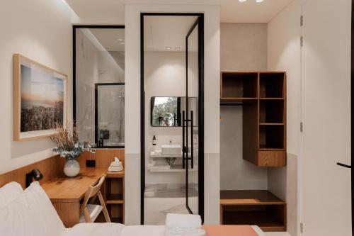 a bedroom with a bed and a desk and a mirror at Zita Beirut in Beirut