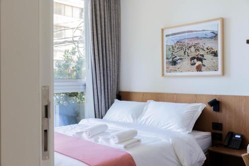 a hotel room with a bed with two white towels at Zita Beirut in Beirut