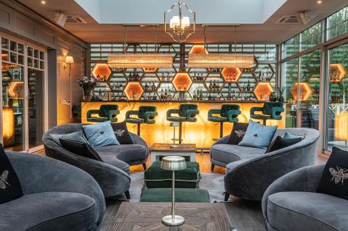 a living room with two couches and a chandelier at Farma Bii in Brzeziny