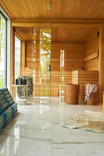 a living room with a blue couch and wooden walls at Farma Bii in Brzeziny