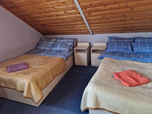 a room with two beds with blue pillows at George&Marry Guest House and hostels in Chişinău