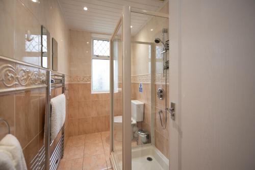 a bathroom with a walk in shower and a toilet at The Prestwick Pad in Prestwick