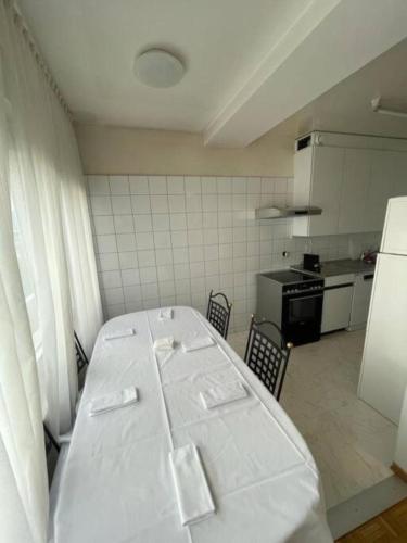 a kitchen with a white table in a room at ONU - PALEXPO-AEROPORT Genève in Geneva