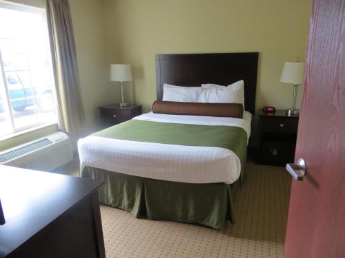 a hotel room with a bed and a window at Cobblestone Inn & Suites - Brillion in Brillion