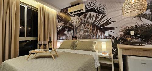 a bedroom with a bed with a table on it at Option Full Service Residence in Rio de Janeiro