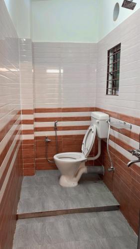 a bathroom with a toilet and a sink at SM LODGE and RESTAURANT in Guwahati