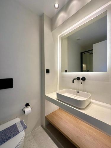 a bathroom with a sink and a mirror at BlueMotion - TwinBedroomPortApartment 1B in Piraeus