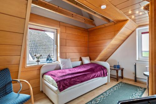 a bedroom with a bed in a room with wooden walls at Ferienhaus Nahe Ostsee in Rövershagen