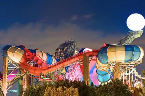 a roller coaster at a carnival at night at Cornich Street - Pearl Room in Abu Dhabi