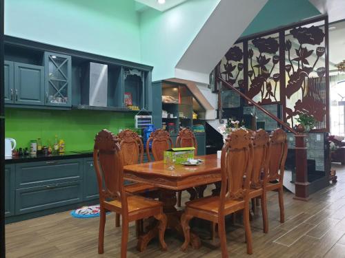 a dining room with a wooden table and chairs at Romantic house with garden in Bien Hoa in Bùi Tiếng