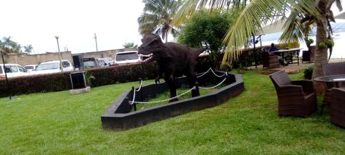 a statue of a dog standing on a fence at GOOLO guesthouse in Jinja