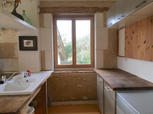 a kitchen with a sink and a window at Hameau de la Brousse in Sers