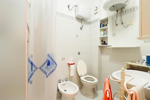 a small bathroom with a toilet and a sink at Cala Rossa Pool & Nature - Goelba in Nisporto