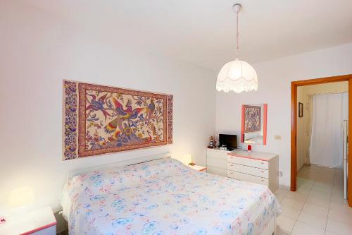 Cala Rossa Pool & Nature - Goelba في Nisporto: غرفة نوم بسرير ودهان على الحائط