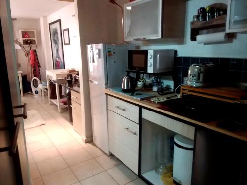a kitchen with a sink and a refrigerator at Charming apartment in Pretoria