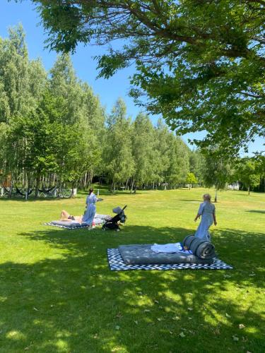 a group of people laying on the grass in a park at Farma Bii in Brzeziny
