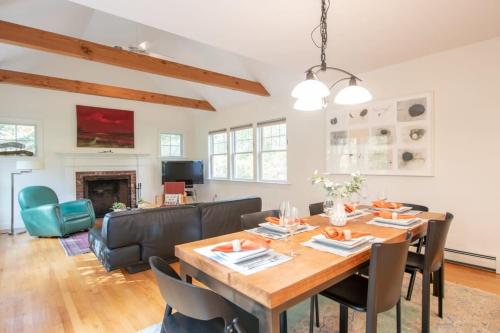 a dining room and living room with a table and chairs at Perfectly private location w deeded beach access in Orleans