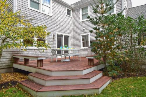 a wooden deck in front of a house at Perfectly private location w deeded beach access in Orleans