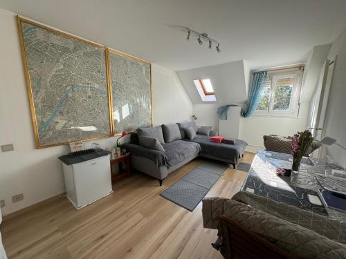 a living room with a large map on the wall at 2 chambres adjacentes avec lit Queen size in Commugny