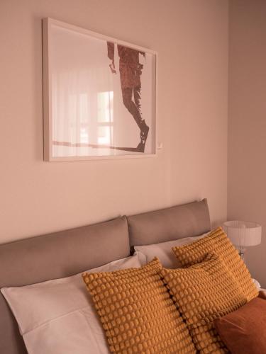 a mirror above a couch with two pillows on it at B&B CCAA Ascona in Ascona