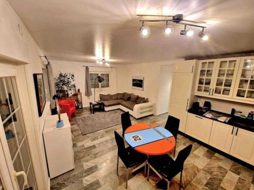 cocina y sala de estar con mesa y sillas. en Appartement calme avec jardin, en Conthey