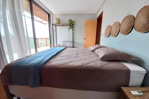 Katil atau katil-katil dalam bilik di Casa confortável com vista mar e piscina