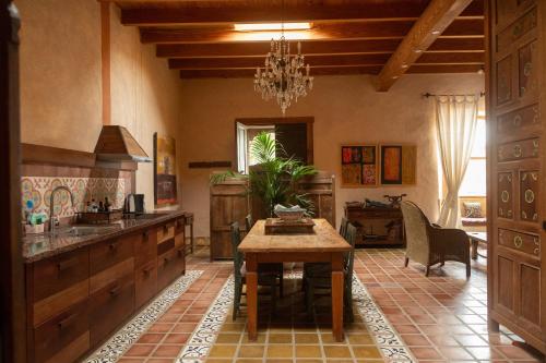 a kitchen with a table and a dining room at Finca Tomaren in San Bartolomé